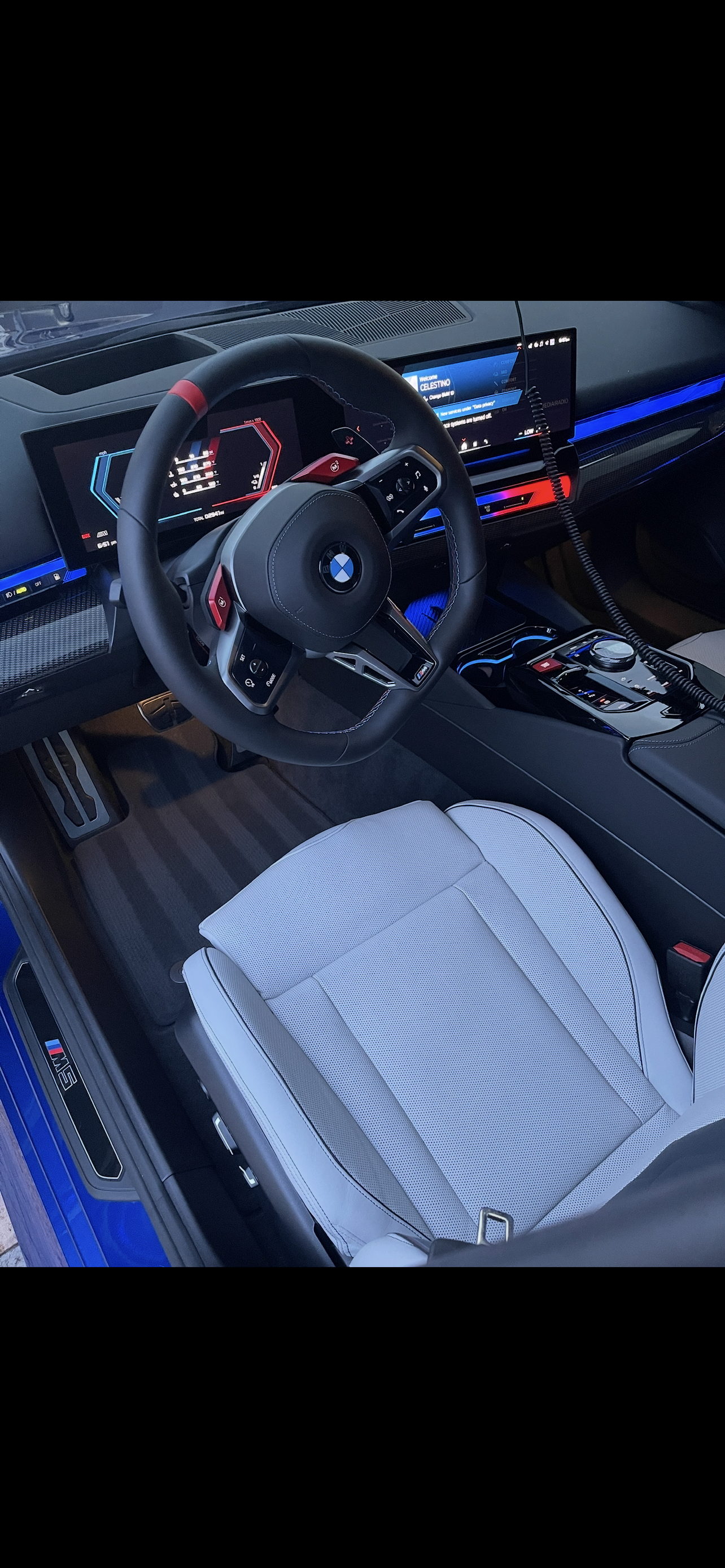BMW M5 luxury interior with blue ambient lighting